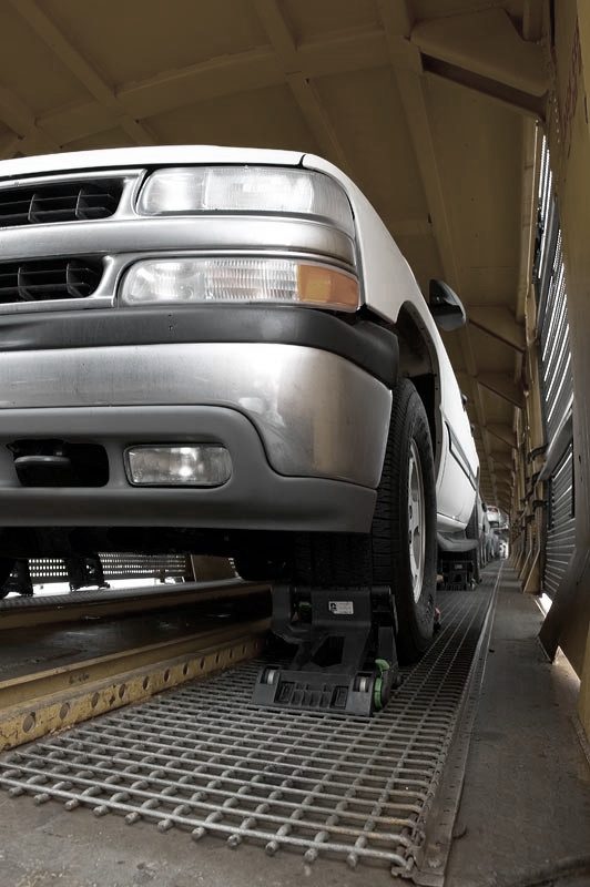 Finished vehicle secured on an autorack railcar deck