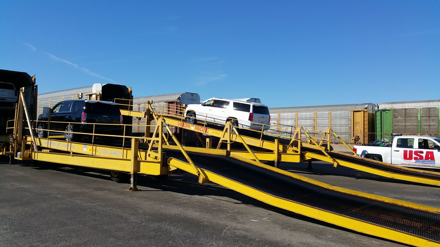 Loading vehicles onto autorack railcars